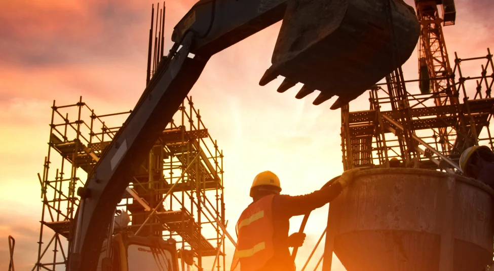 industrial construction worker next to a crane